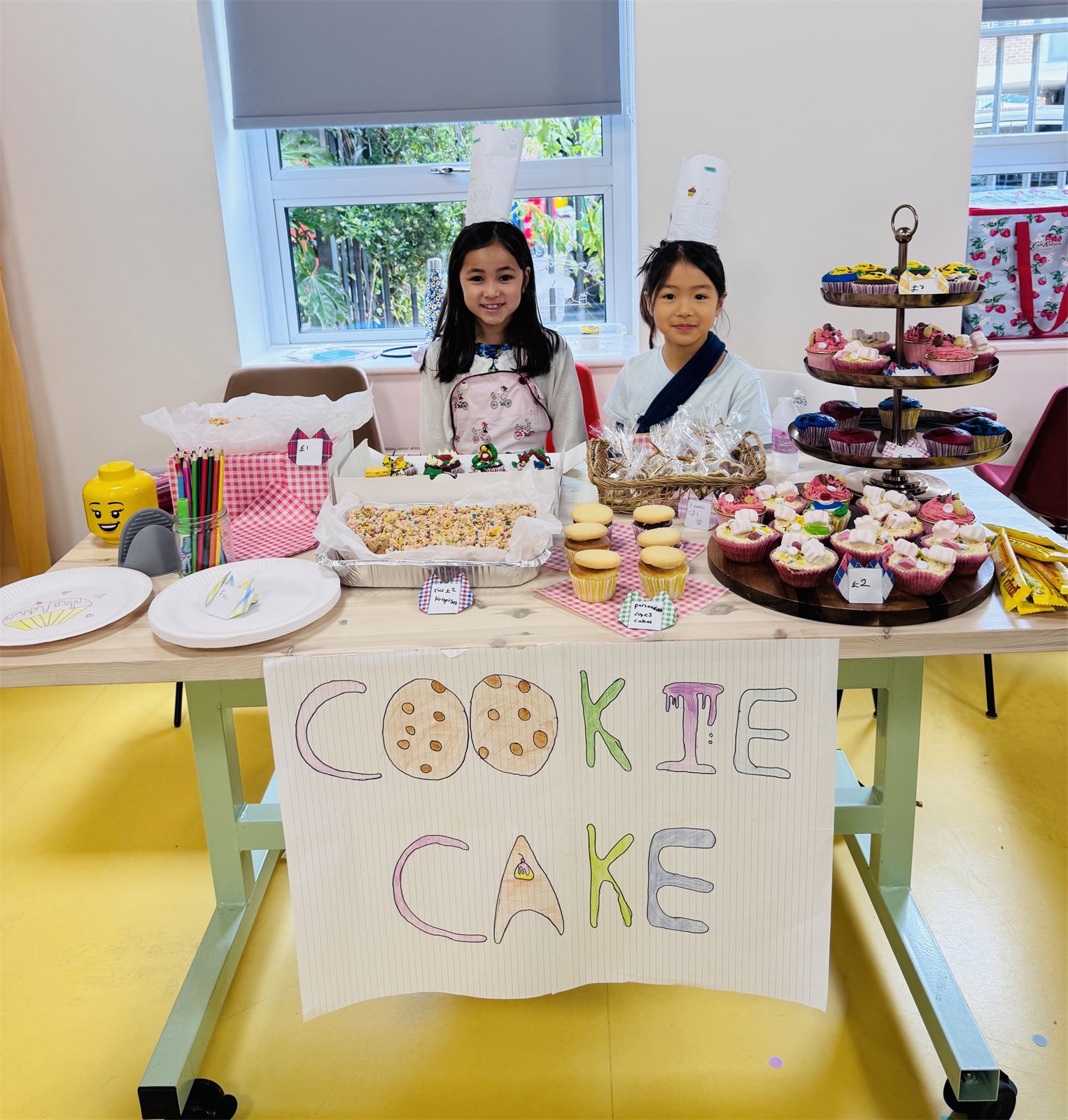 Children selling cakes they made at their stall